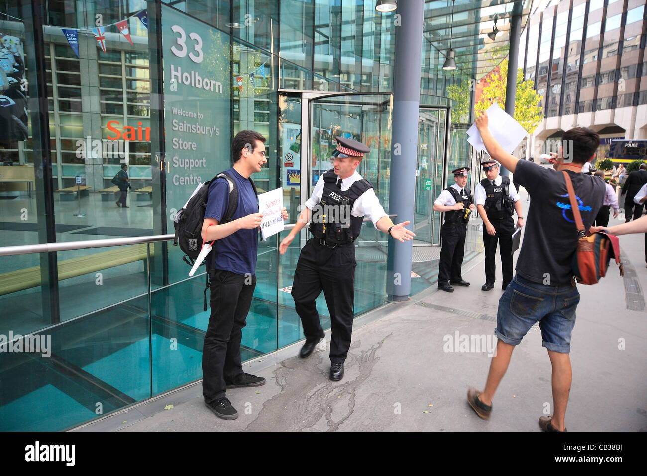 Monday 28th May 2012 Pay Up group target Sainsbury's head office as they call on the company to pay workers a living wage, Police move in to clear protesters from the property. Credit Line : Credit:  HOT SHOTS / Alamy Live News Stock Photo