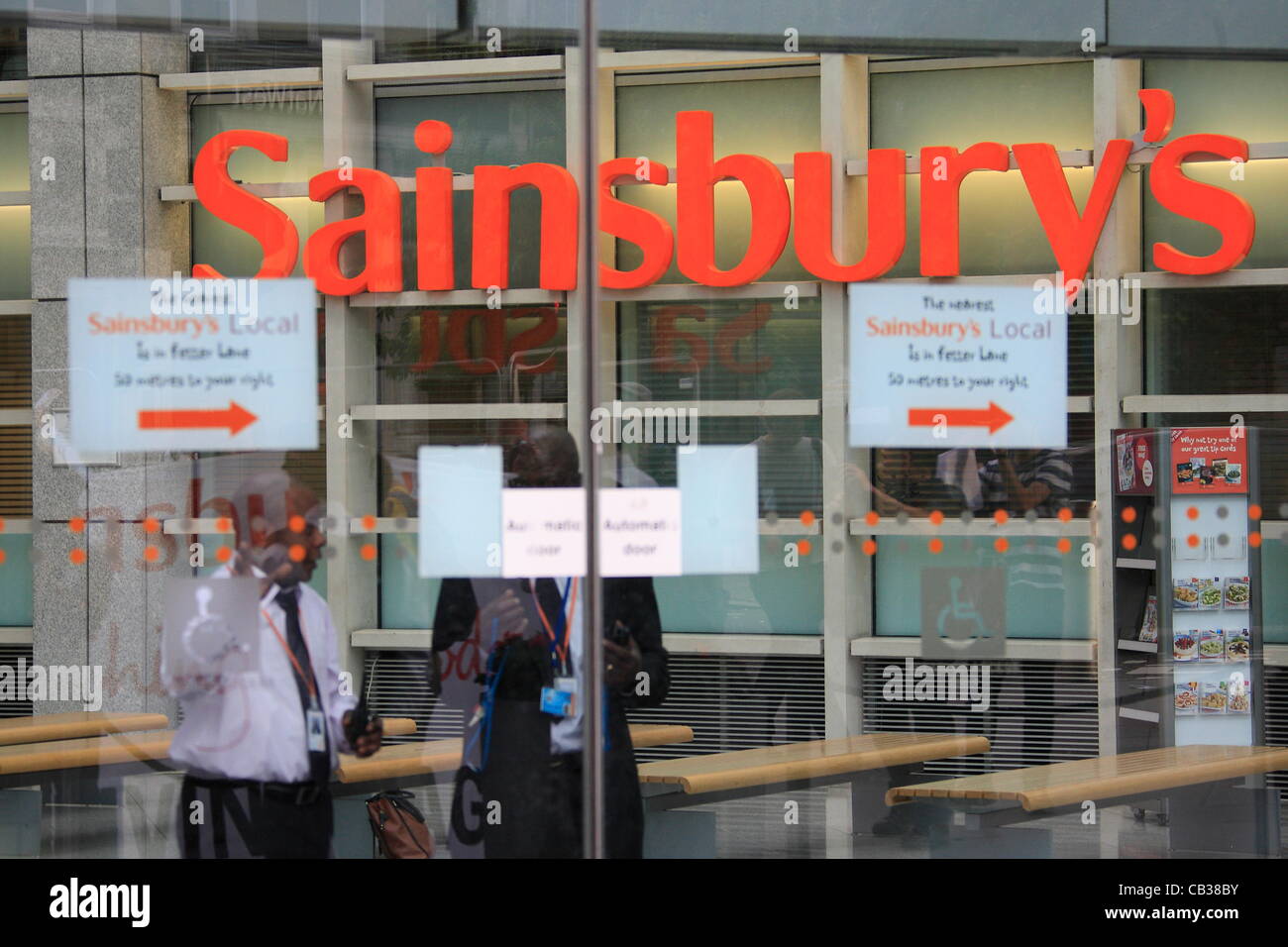 Monday 28th May 2012 Pay Up group target Sainsbury's head office as they call on the company to pay workers a living wage, security staff  behind locked doors to prevent activists from entering the building. Credit Line : Credit:  HOT SHOTS / Alamy Live News Stock Photo
