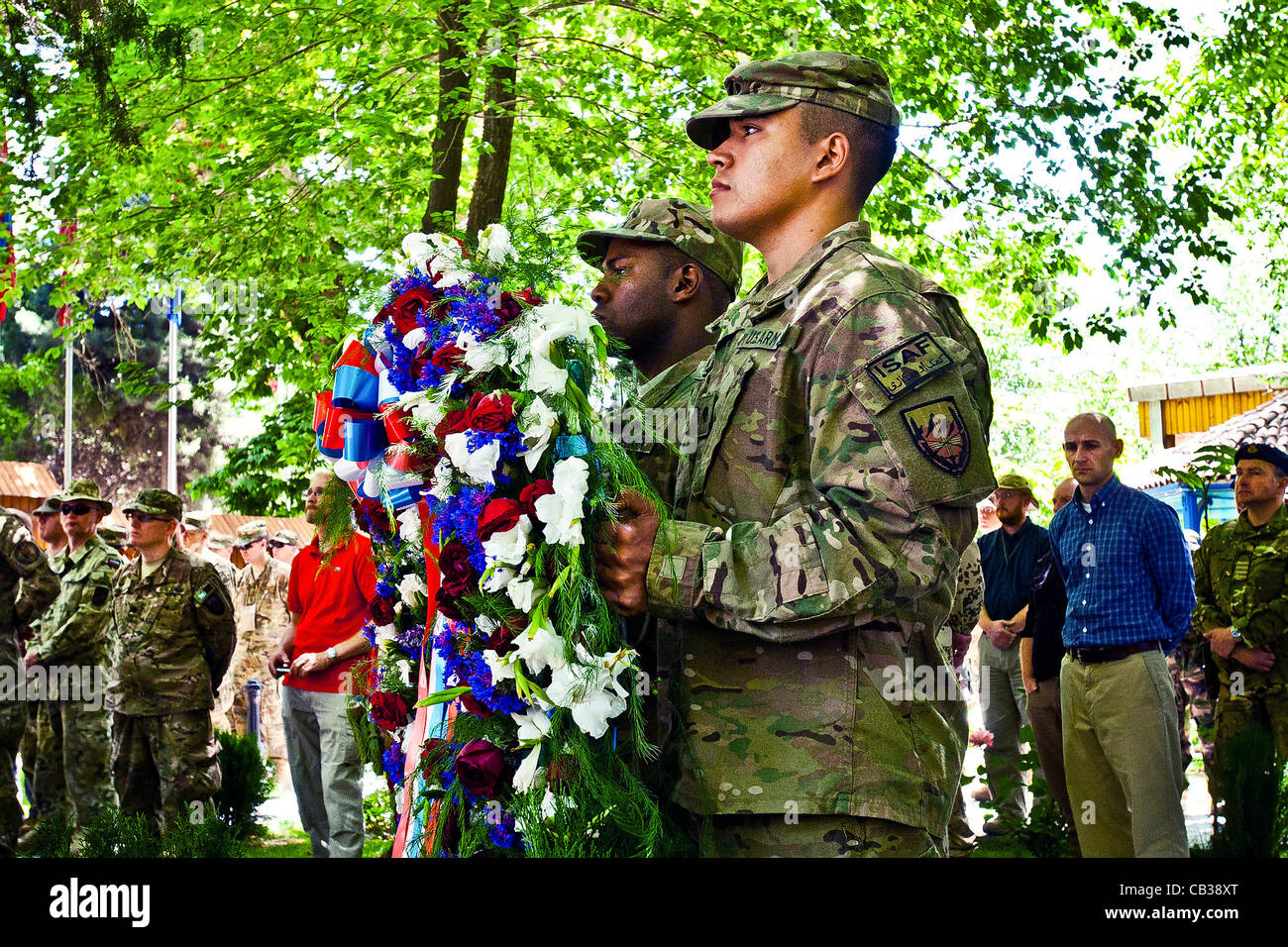 US service members prepare to present a wreath during a Memorial Day ceremony at the International Security Assistance Force headquarters May 28, 2012 in Kabul, Afghanistan. Stock Photo