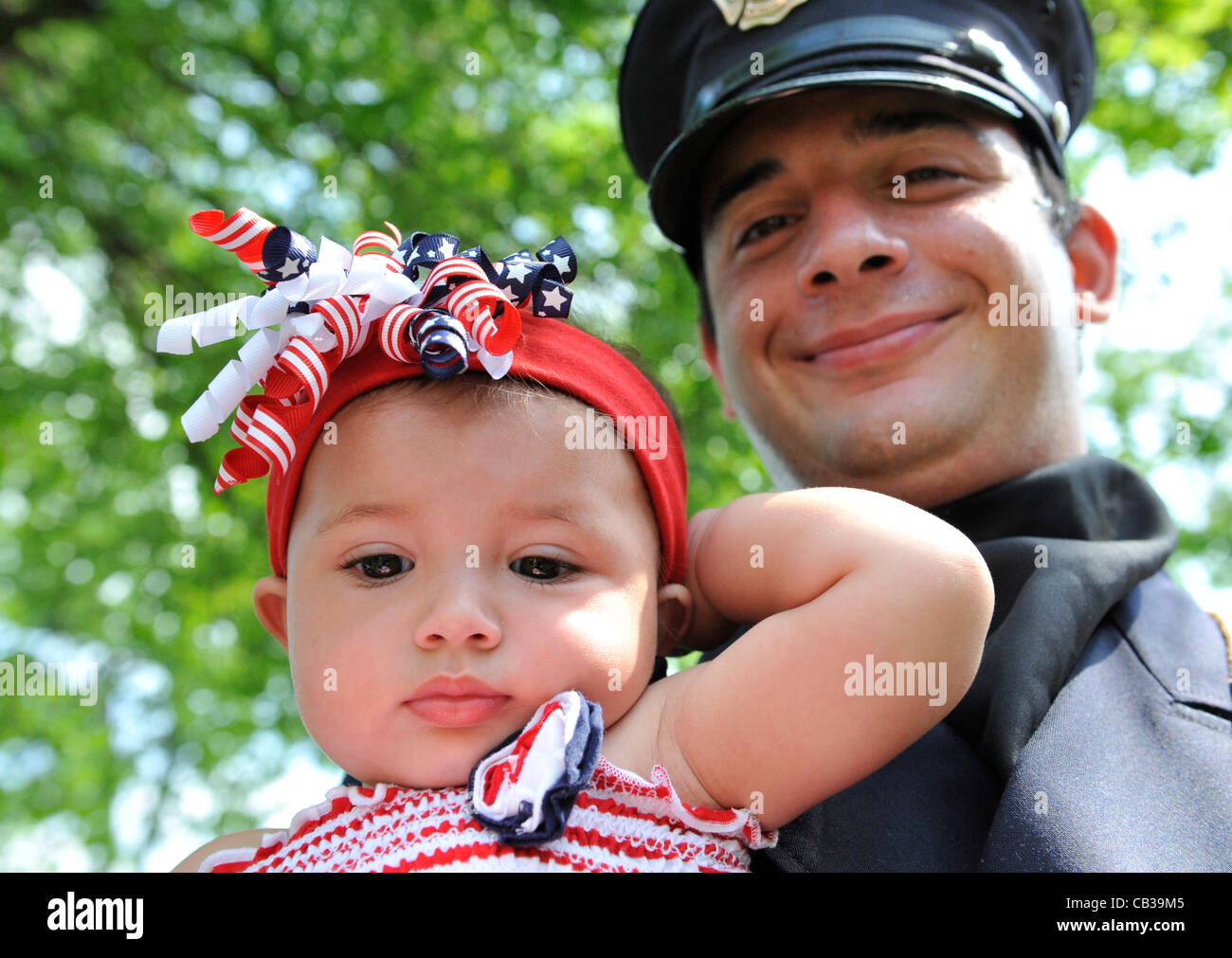 Merrick firefighter band member holds his 10month old niece in the