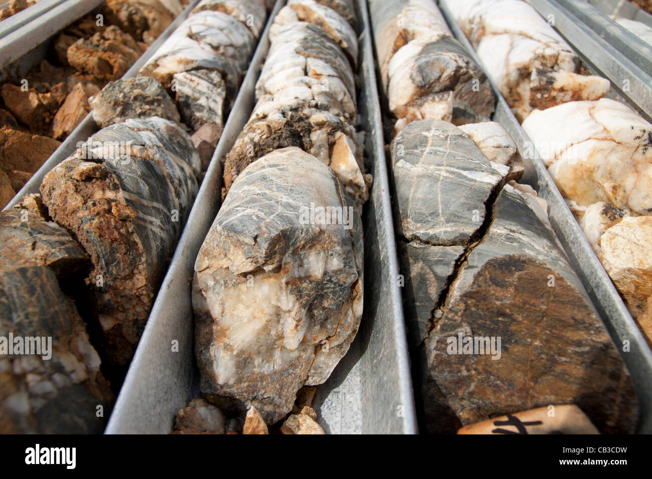 Severely broken, weathered, fractured and faulted NQ diamond drill core Stock Photo