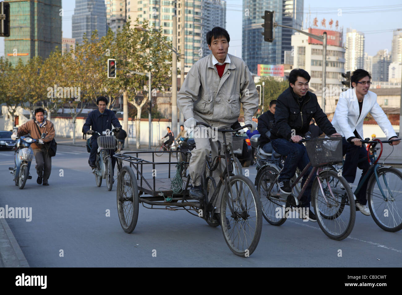 migrant workers commuting cycling over bridge in Shanghai, China, Asia ...