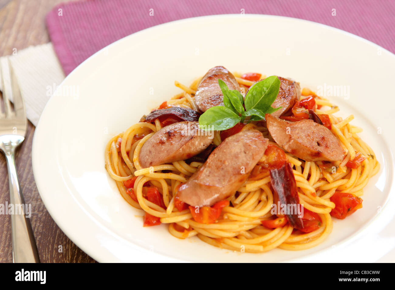 Pasta with sausage and tomato Stock Photo