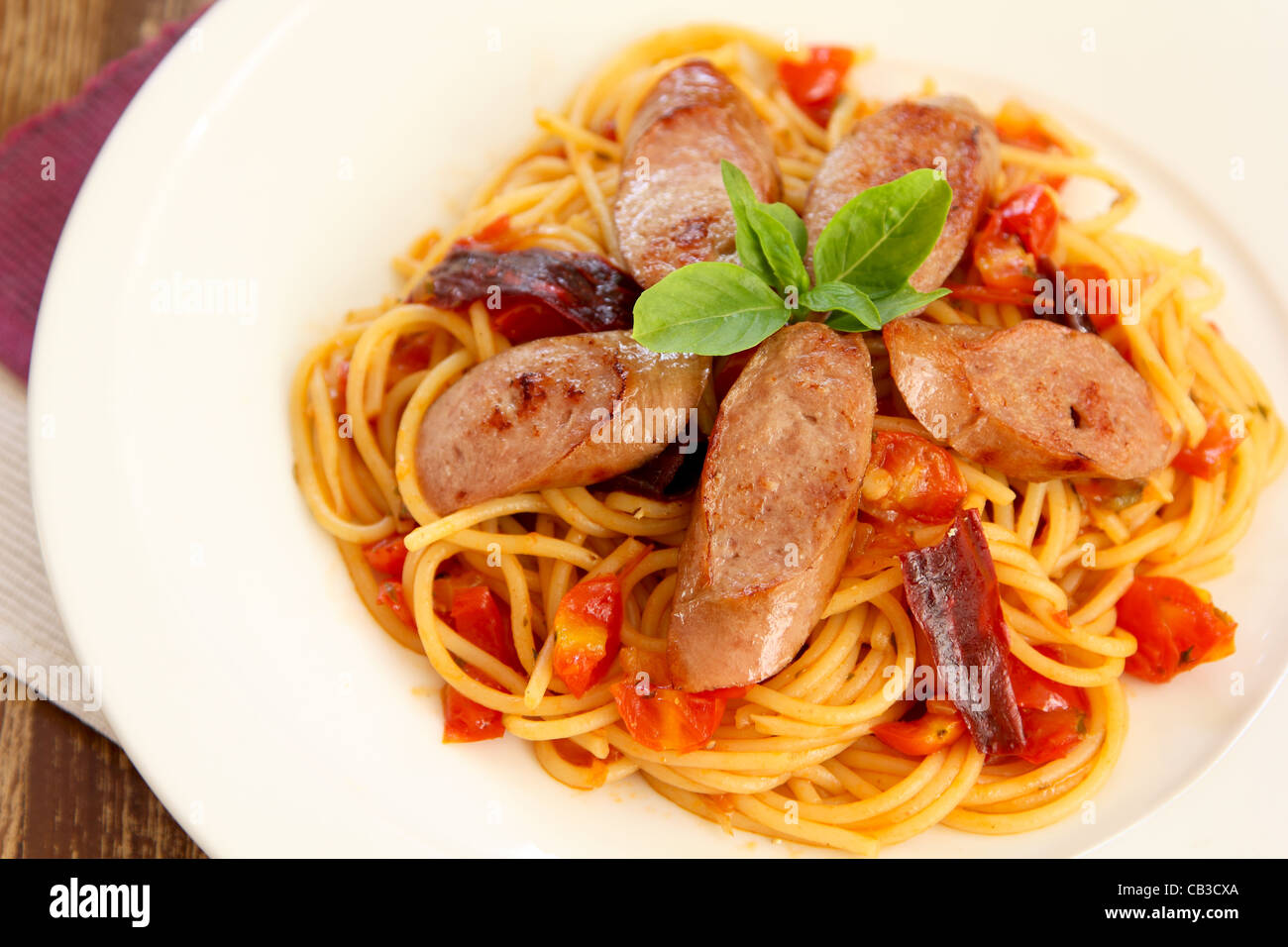Pasta with sausage and tomato Stock Photo