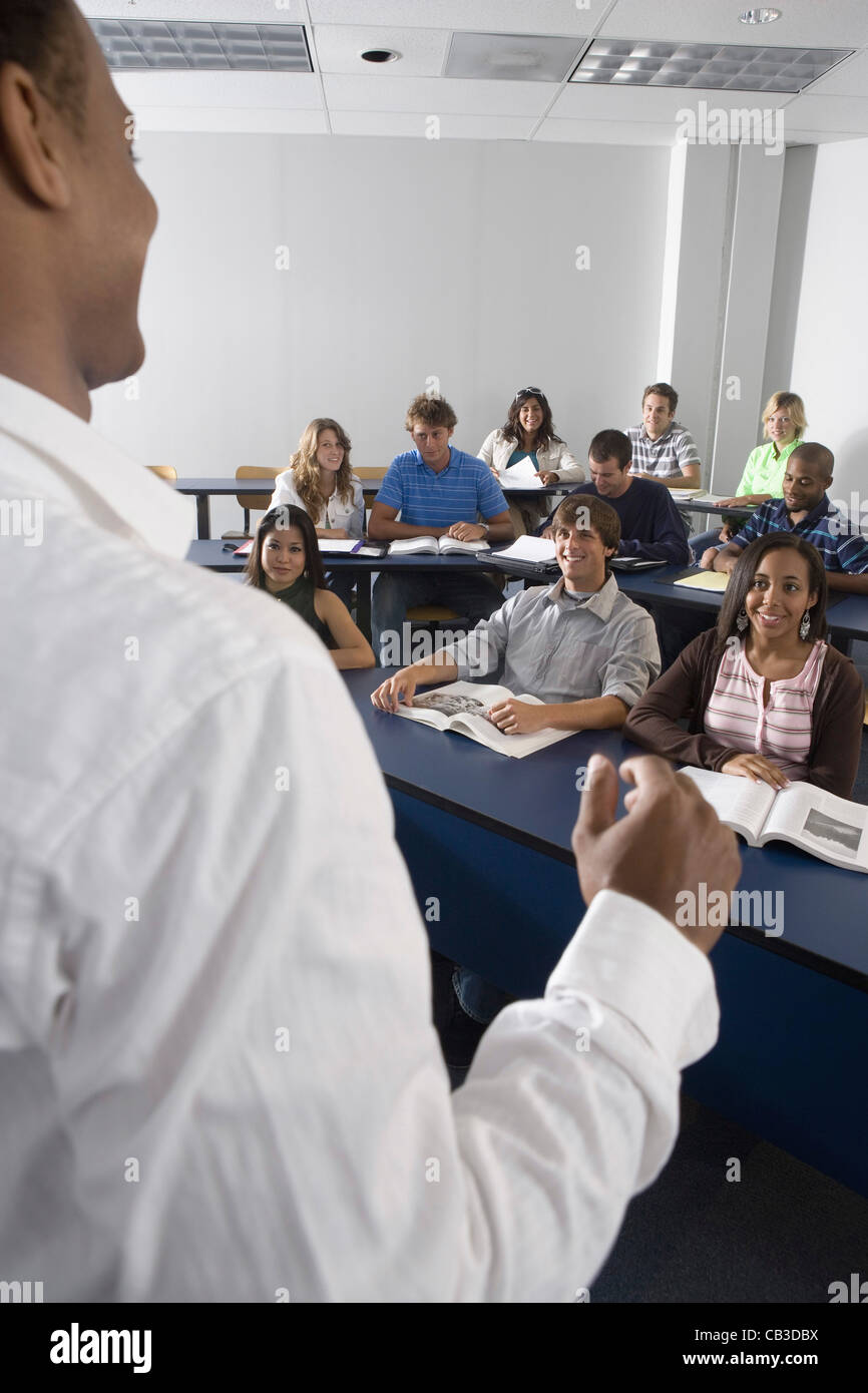 Teacher teaching students in the classroom Stock Photo - Alamy