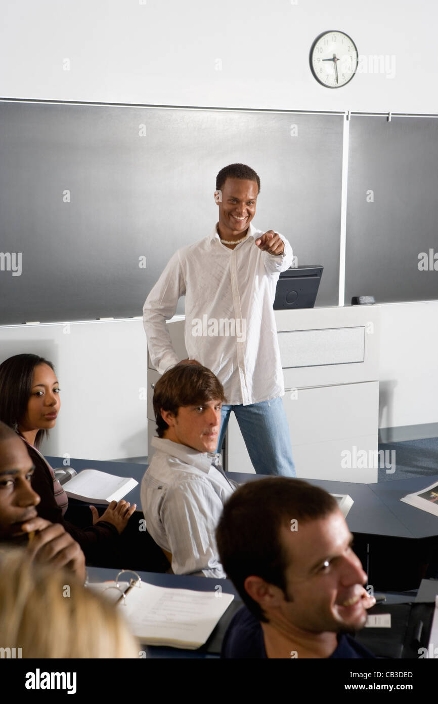 Teacher teaching students in the classroom Stock Photo - Alamy