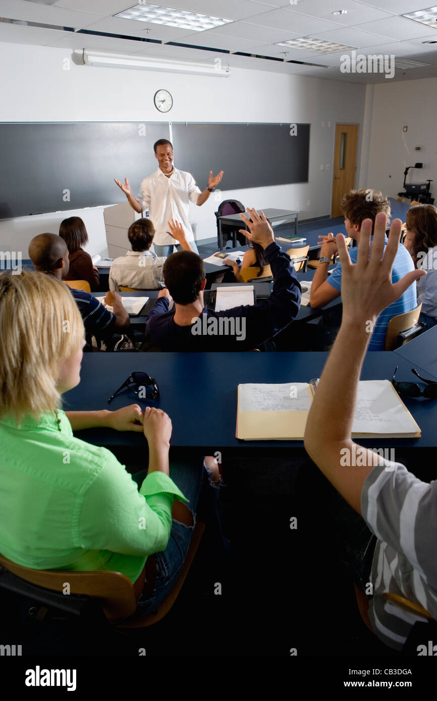 Students raising their hands in class hi-res stock photography and ...