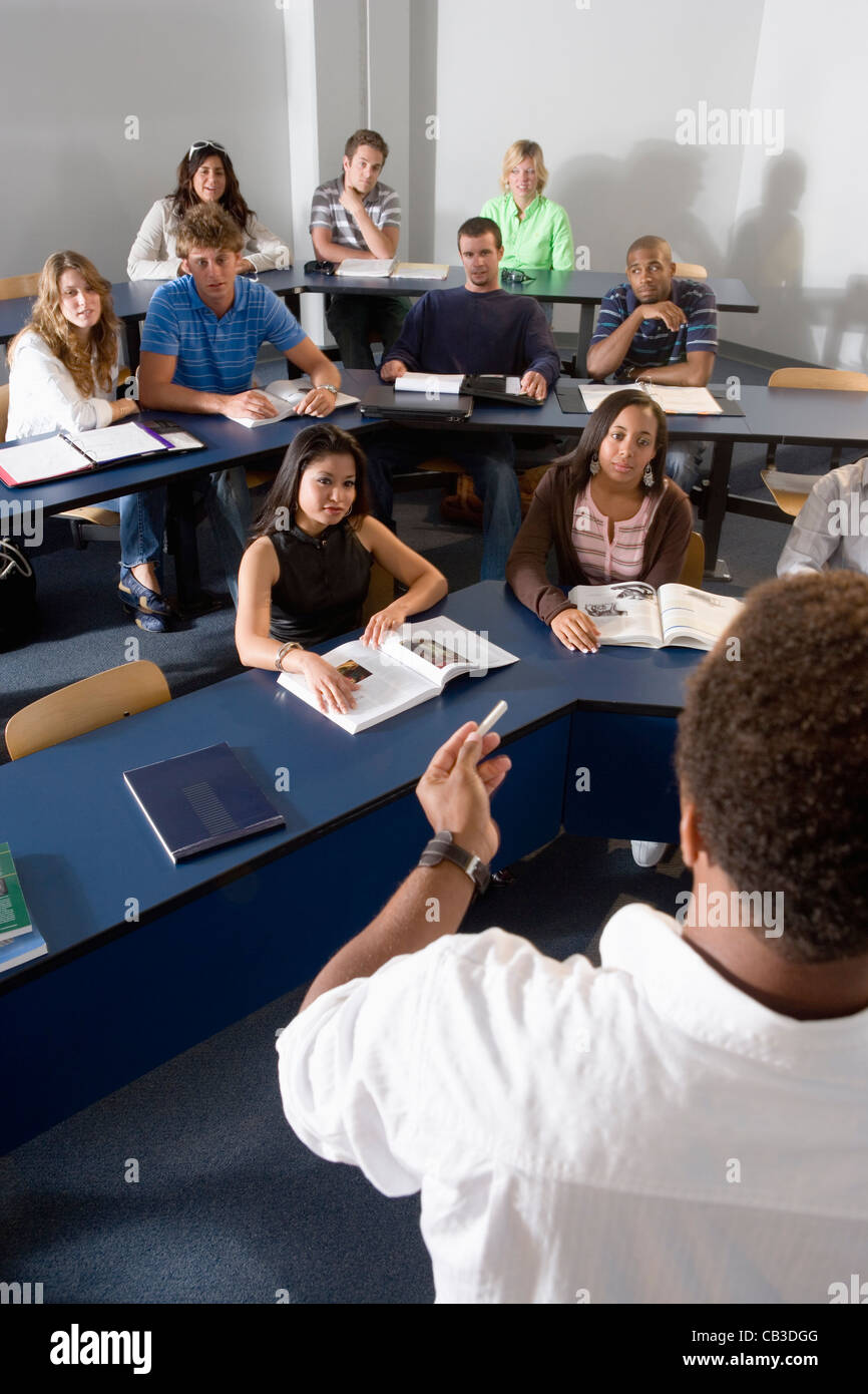 Teacher teaching students in the classroom Stock Photo - Alamy