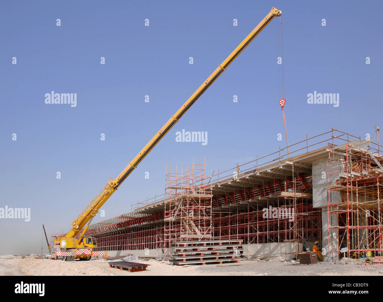 A mobile crane operates on a road construction site in Dubai. Part of the new Parallel Road Scheme Stock Photo