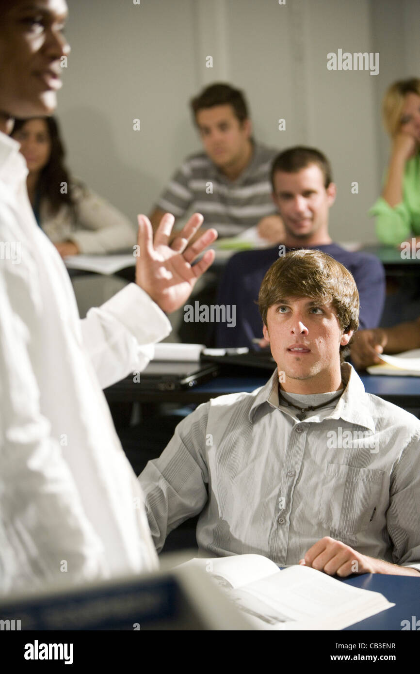 Teacher teaching students in the classroom Stock Photo - Alamy