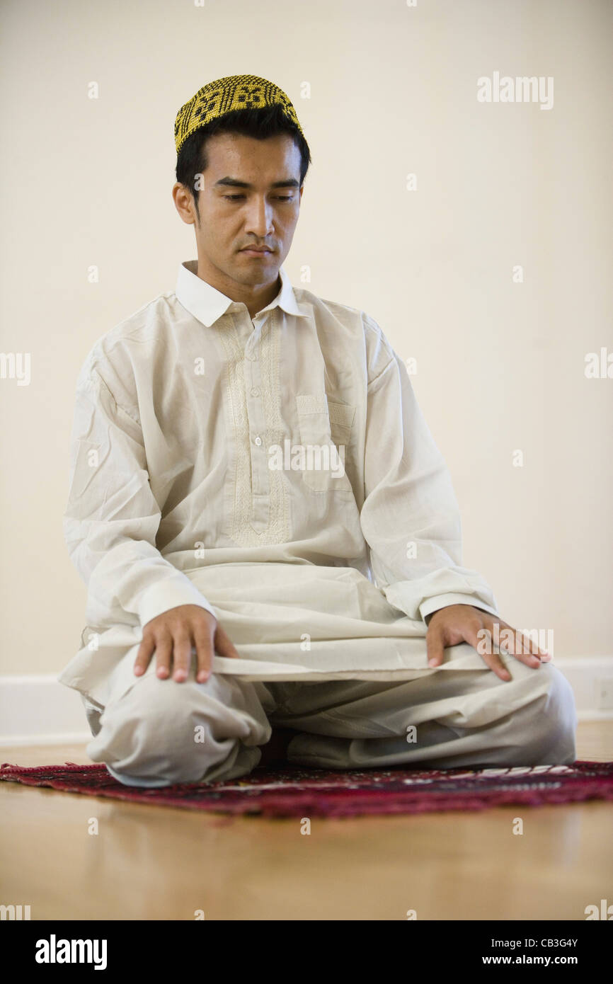 Man prays on his knees hi-res stock photography and images - Alamy