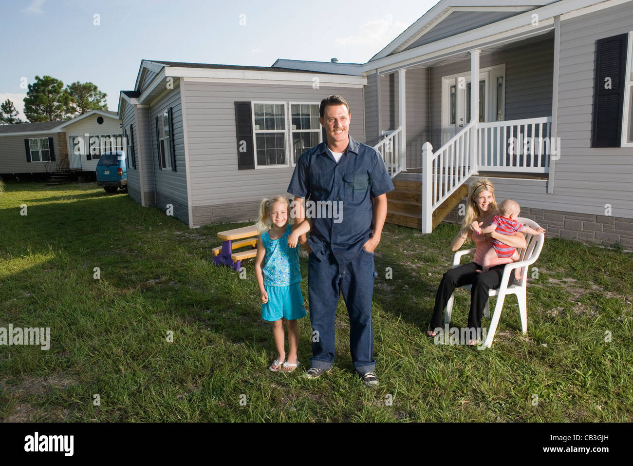 Portrait of a bluecollar family in front of a trailer home Stock Photo Alamy
