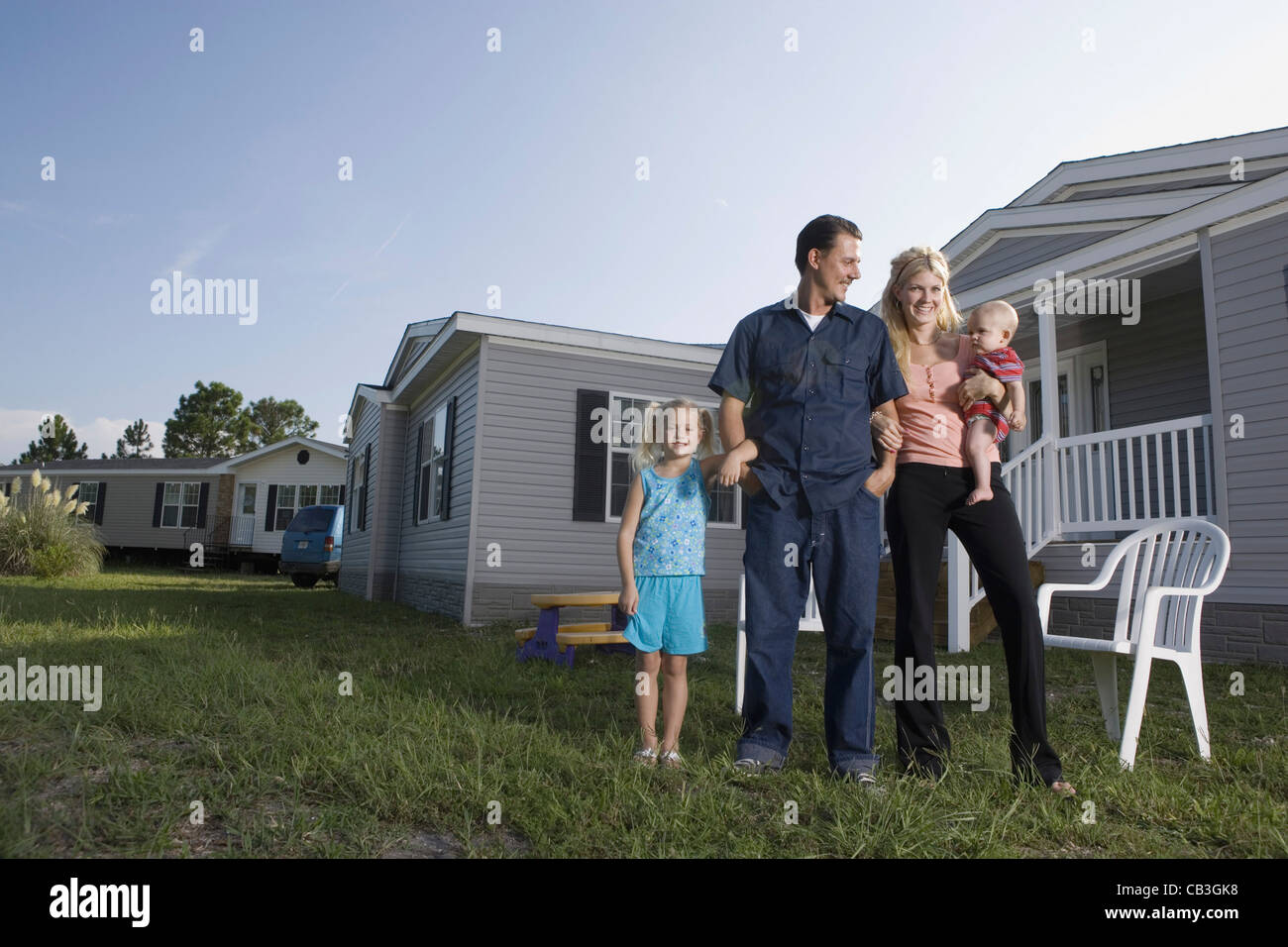 Portrait of bluecollar family in front of a trailer home Stock Photo Alamy