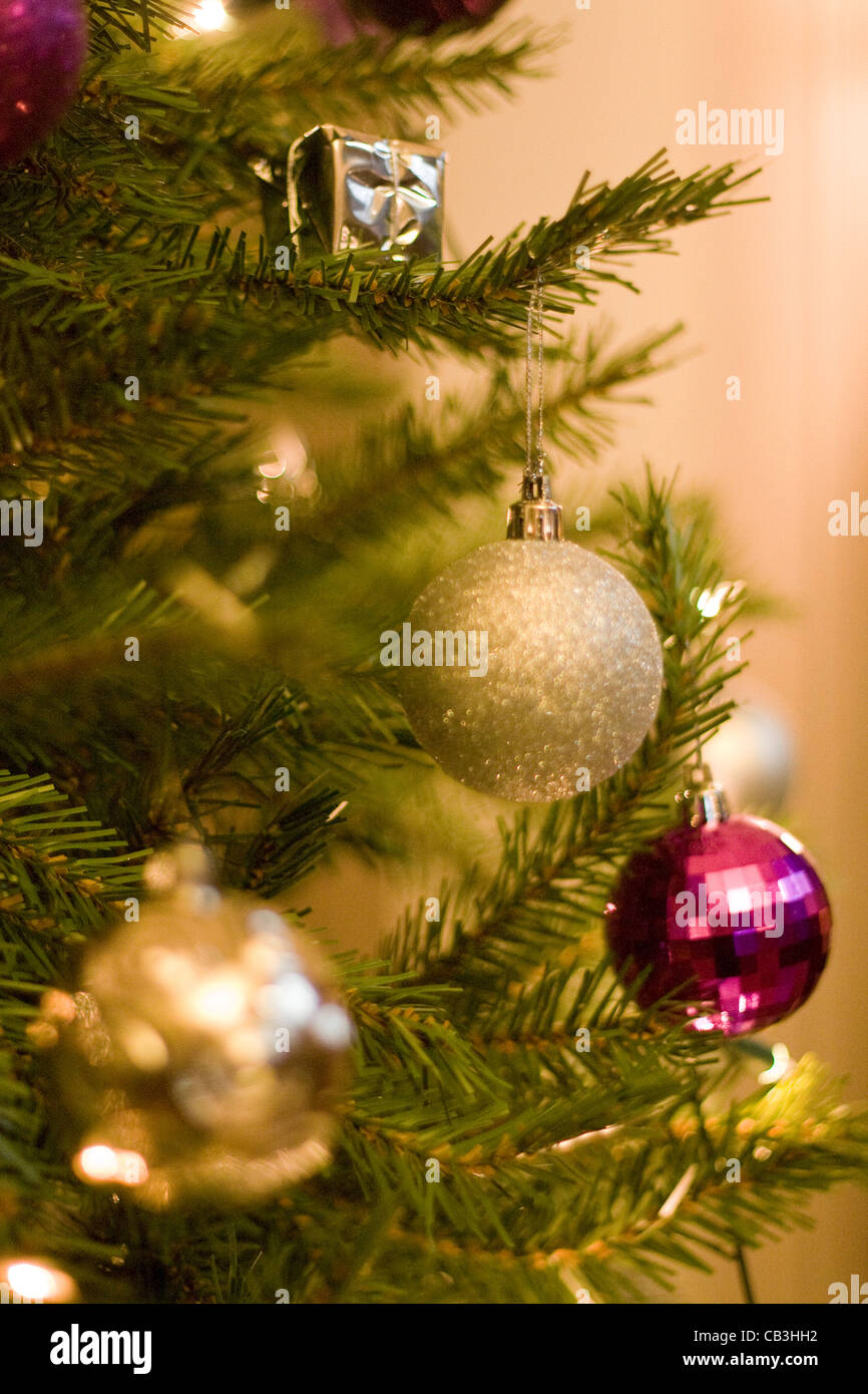 A close up view of a decorated Christmas Tree with barbels in and out of focus on as well as presents Stock Photo