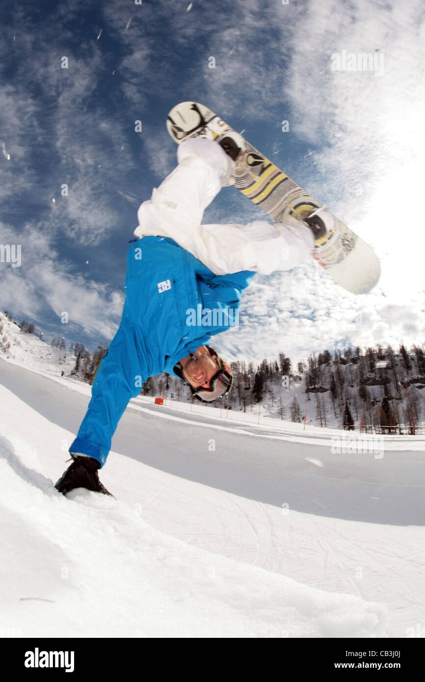 Snowboarder perfoming a trick or stunt close-up on a sunny day in wintersport Stock Photo