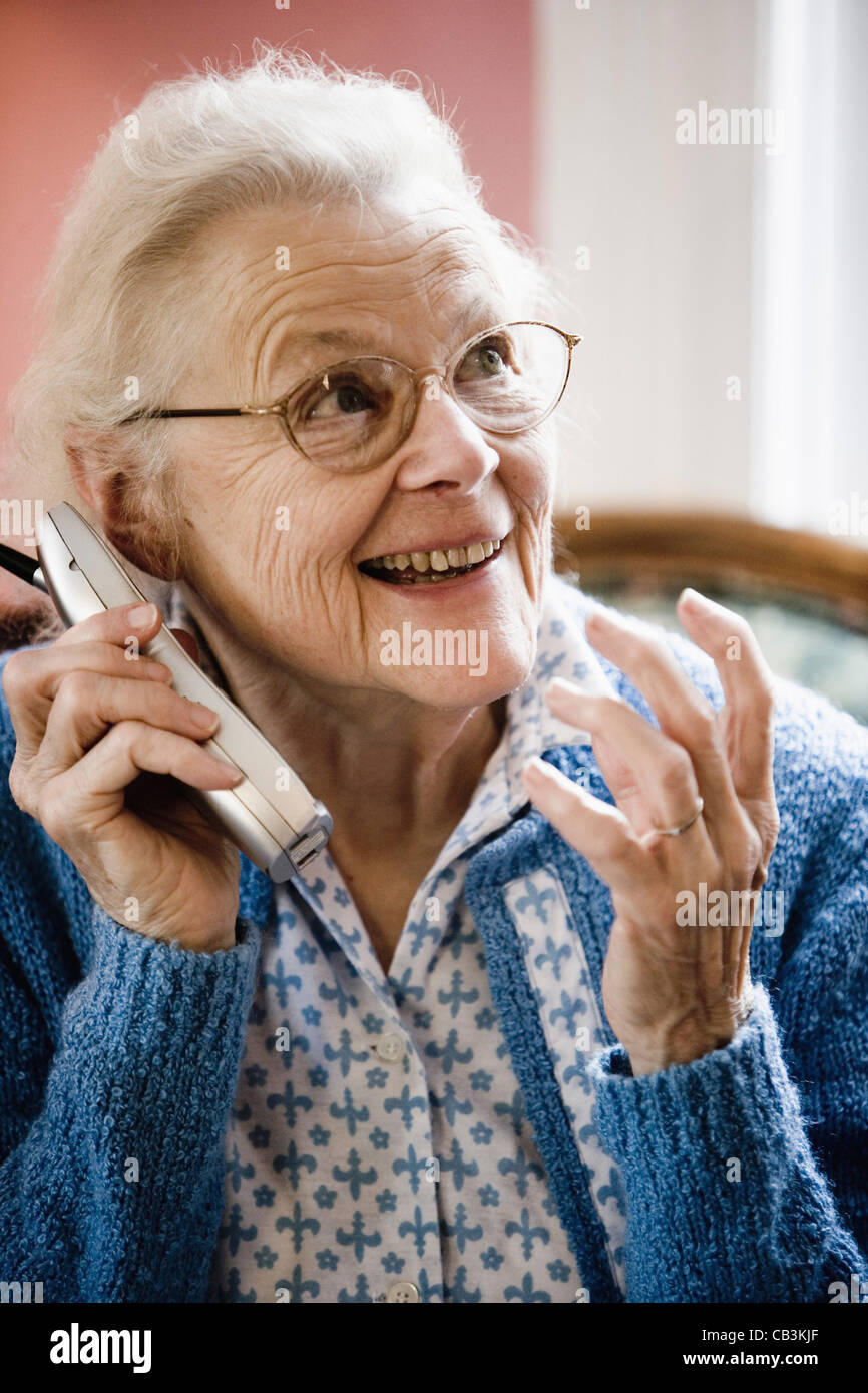 Excited and happy senior woman talking on cordless phone Stock Photo ...