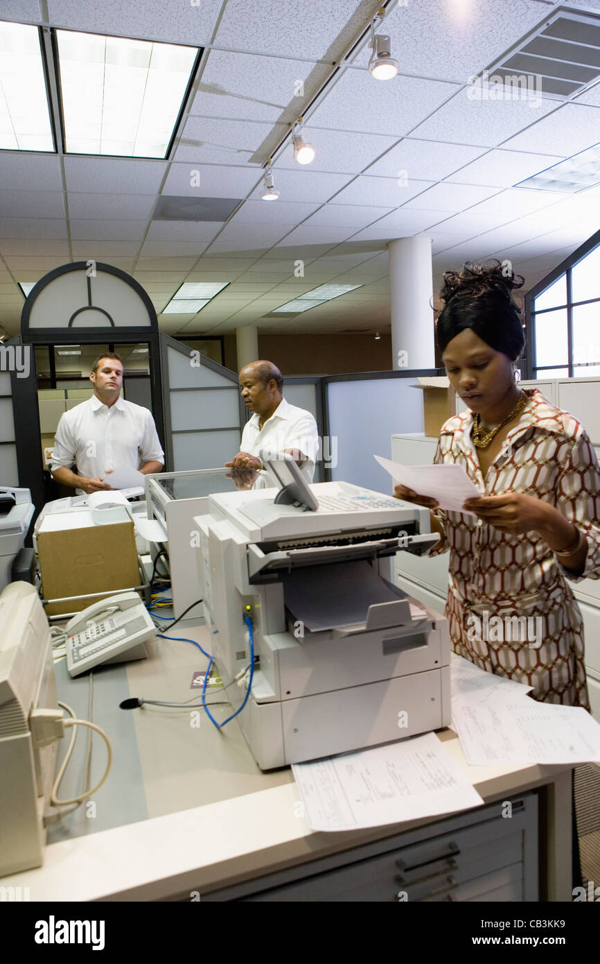 Office workers using office equipment Stock Photo Alamy