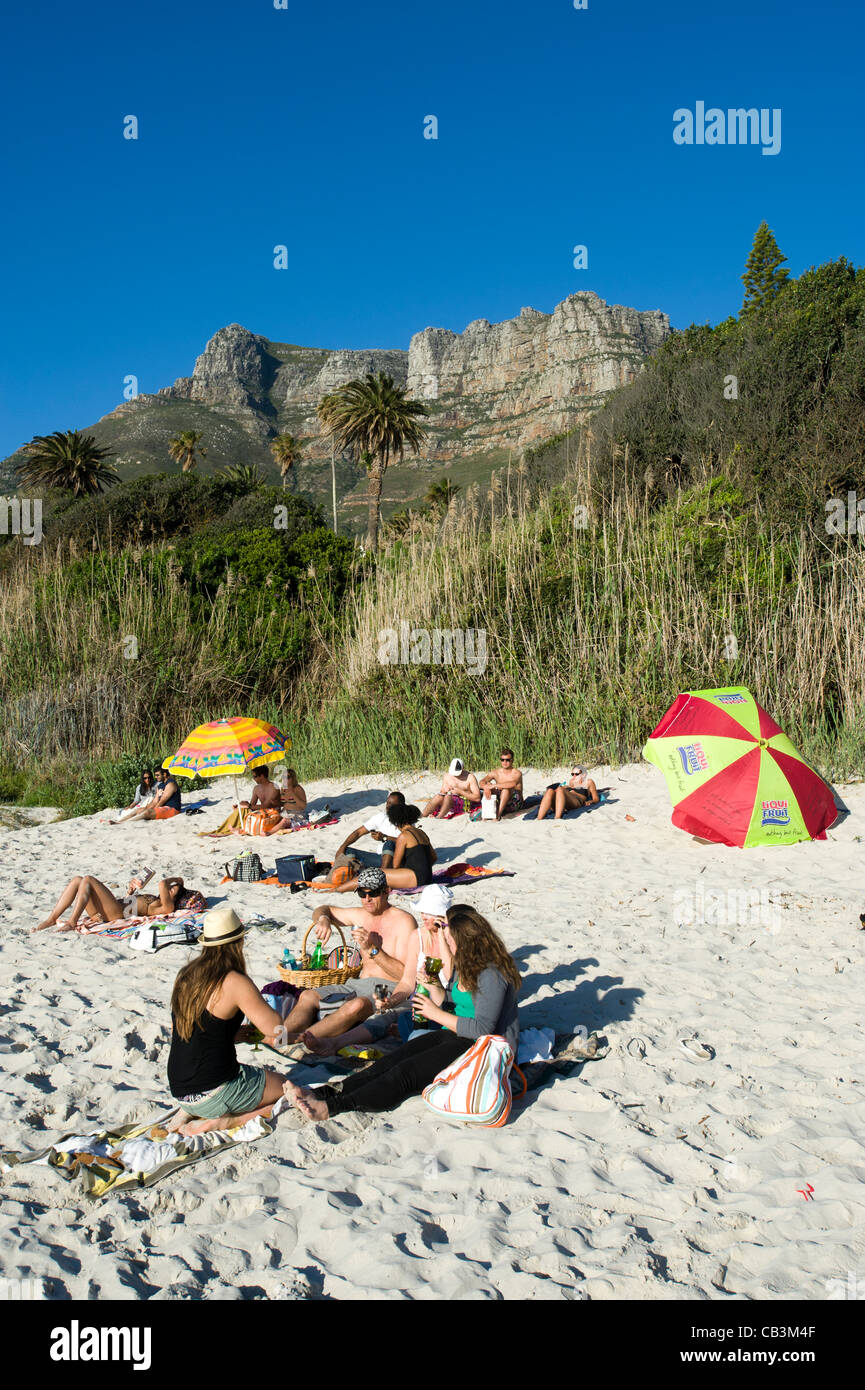 Young people relax at Llandudno beach Cape Town South Africa Stock Photo