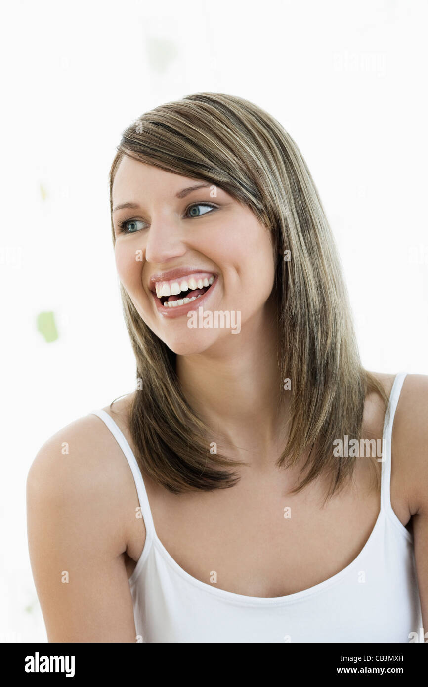 Studio portrait of young woman smiling Stock Photo - Alamy
