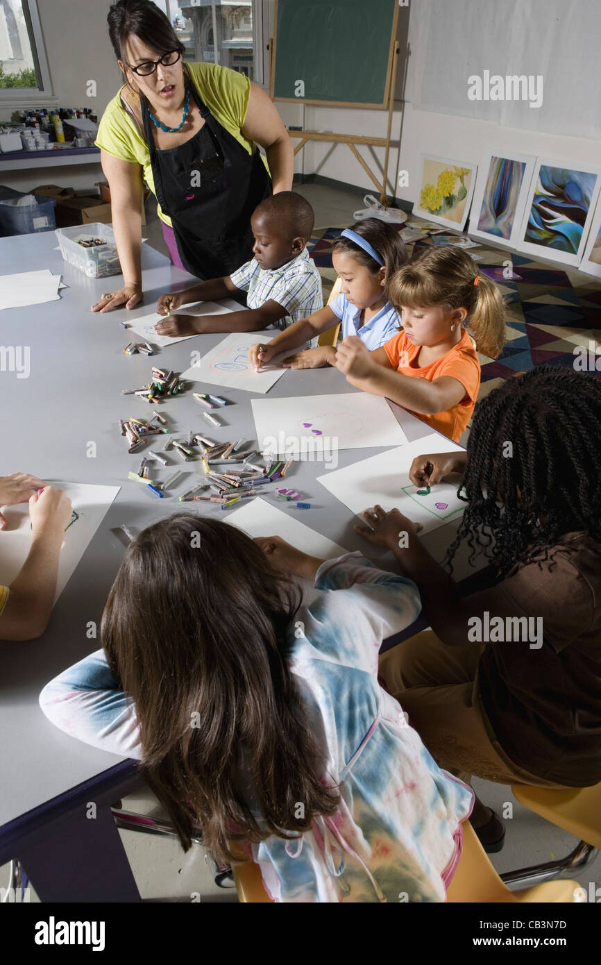 An art teacher teaching young students in art class Stock Photo Alamy