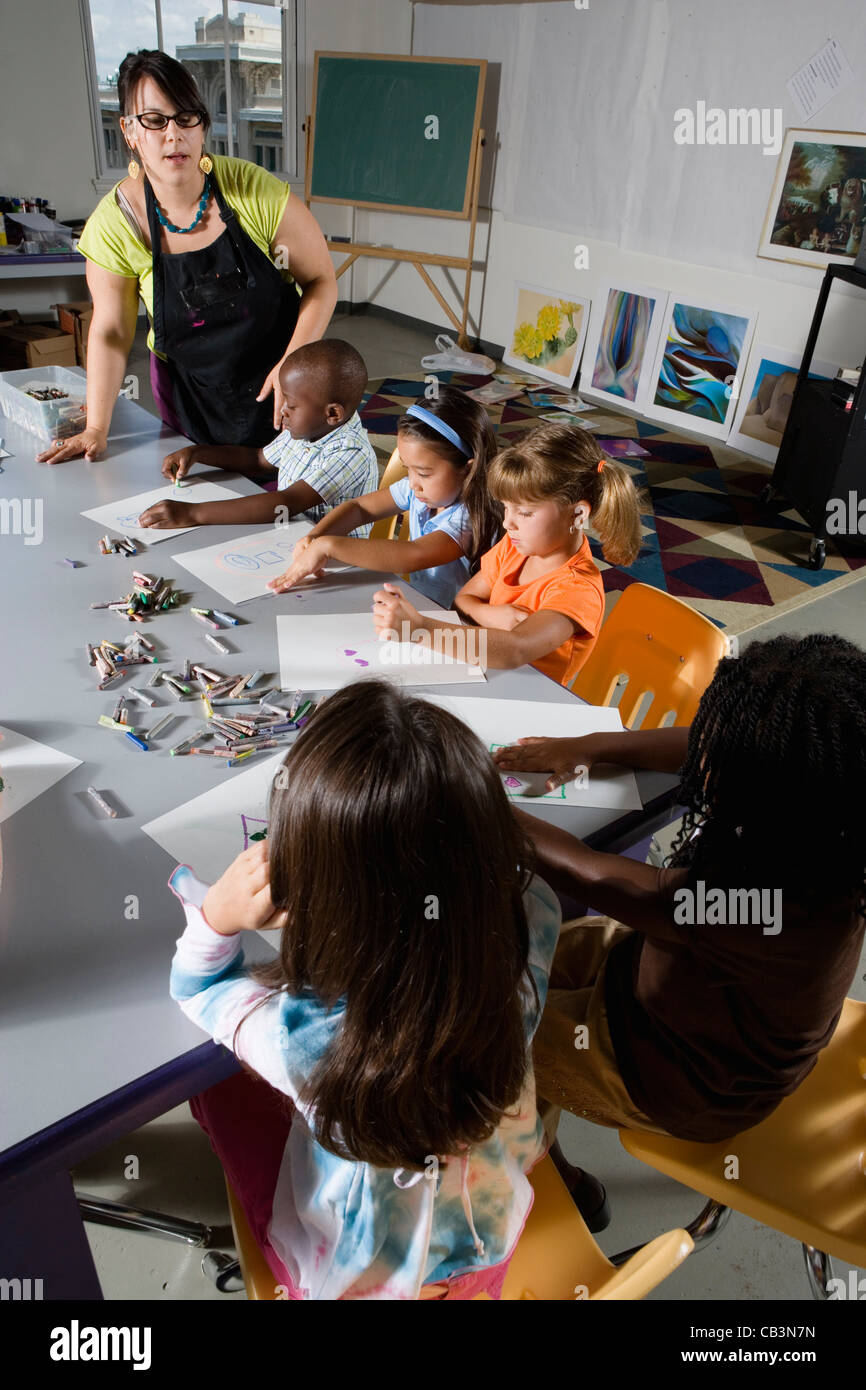 An art teacher teaching young students in art class Stock Photo Alamy