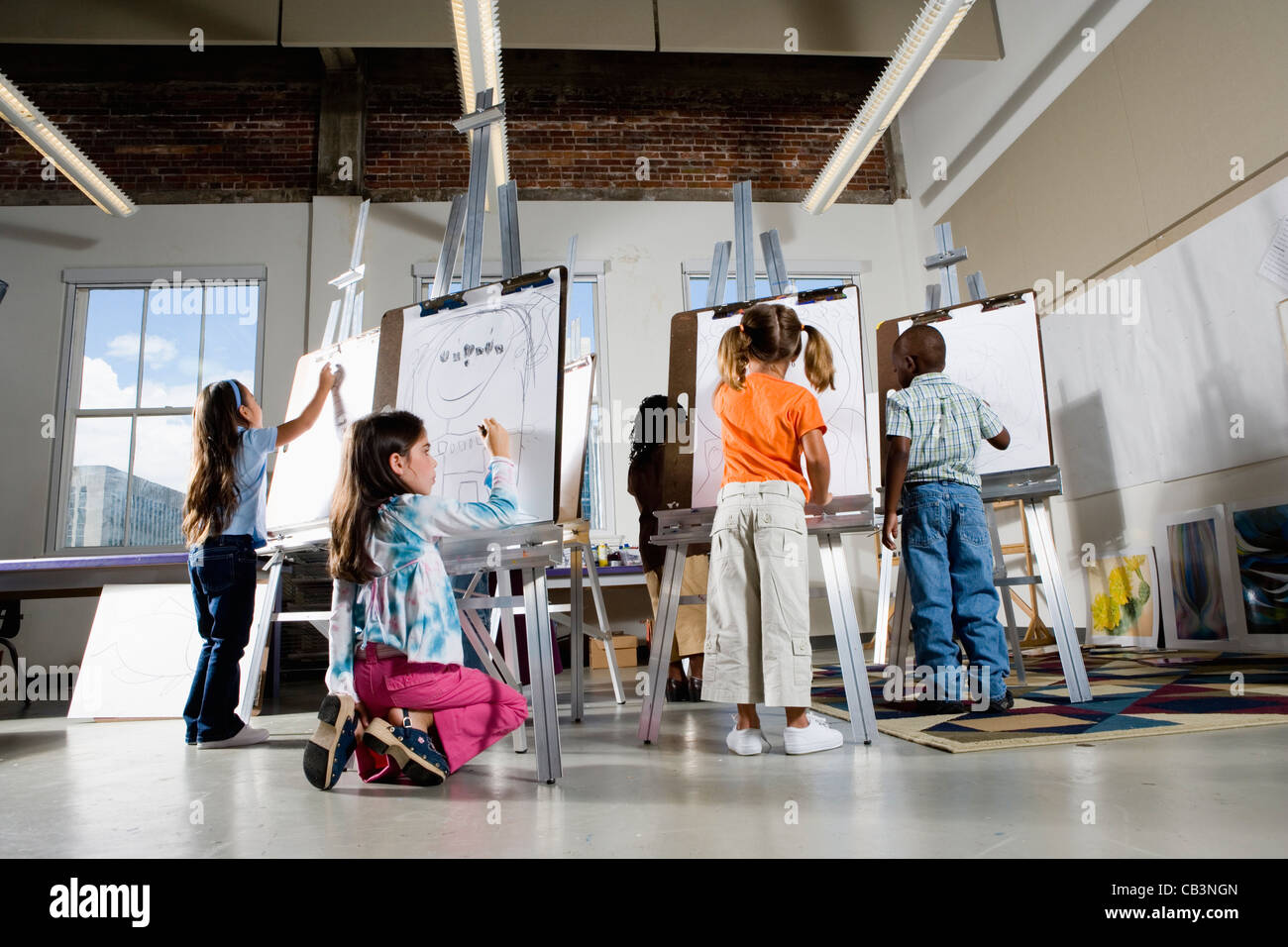 Children drawing on easels in art class Stock Photo - Alamy