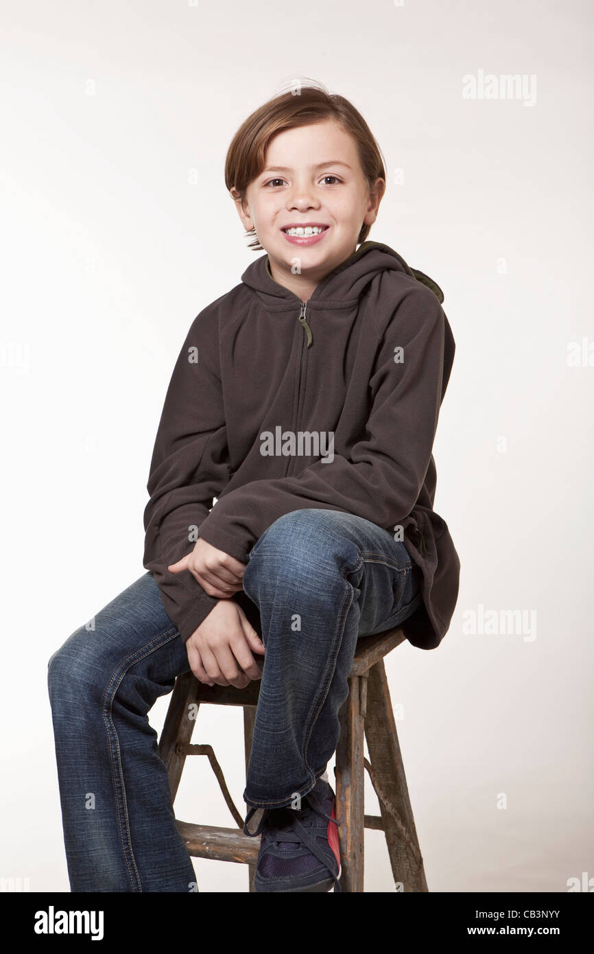 Portrait boy sitting stool hi-res stock photography and images - Alamy