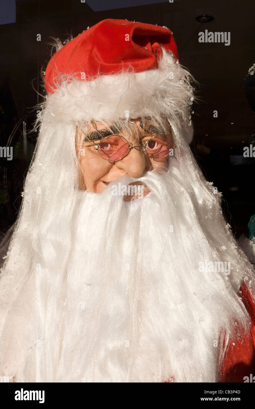 A Santa Christmas party costume is displayed in the front window of a fancy dress shop in Goven Hill, south Glasgow. Stock Photo