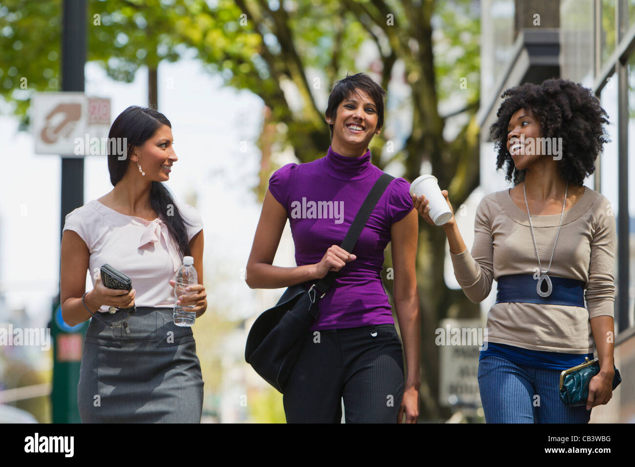 Three businesswomen walking in street downtown Stock Photo - Alamy