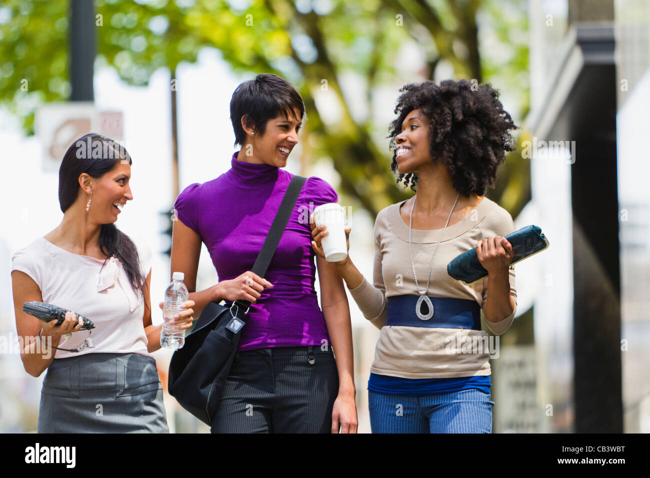 Three businesswomen walking in street downtown Stock Photo - Alamy