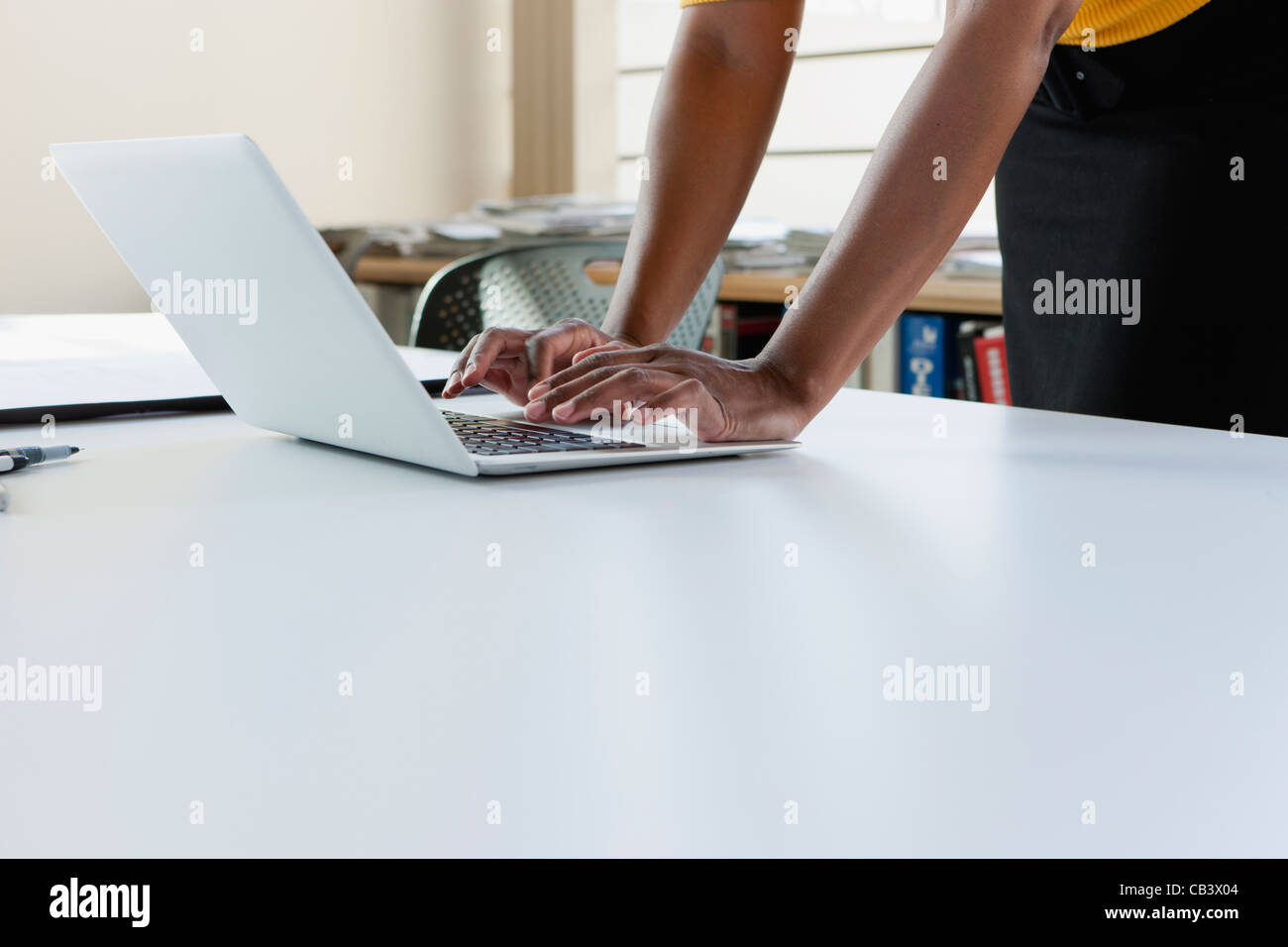 Woman's hands on computer Stock Photo - Alamy