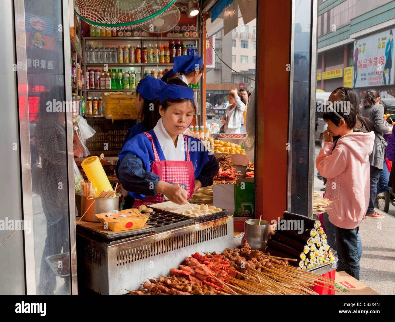 chinese woman selling freshly prepared chinese food snacks from a street  corner stall Chengdu PRC, People's Republic of China Stock Photo - Alamy