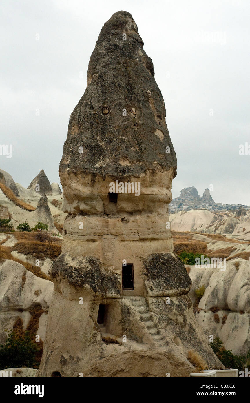 Tall conical rocks provide cave dwellings in Cappadocia's bizarre volcanically formed landscape Stock Photo