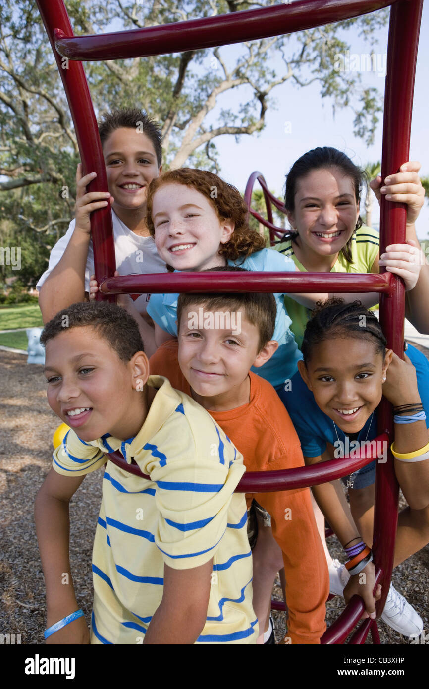 Portrait of children climbing on monkey bars at a playground Stock ...