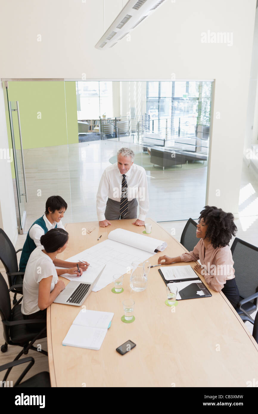 Project discussions amongst employees in boardroom Stock Photo - Alamy