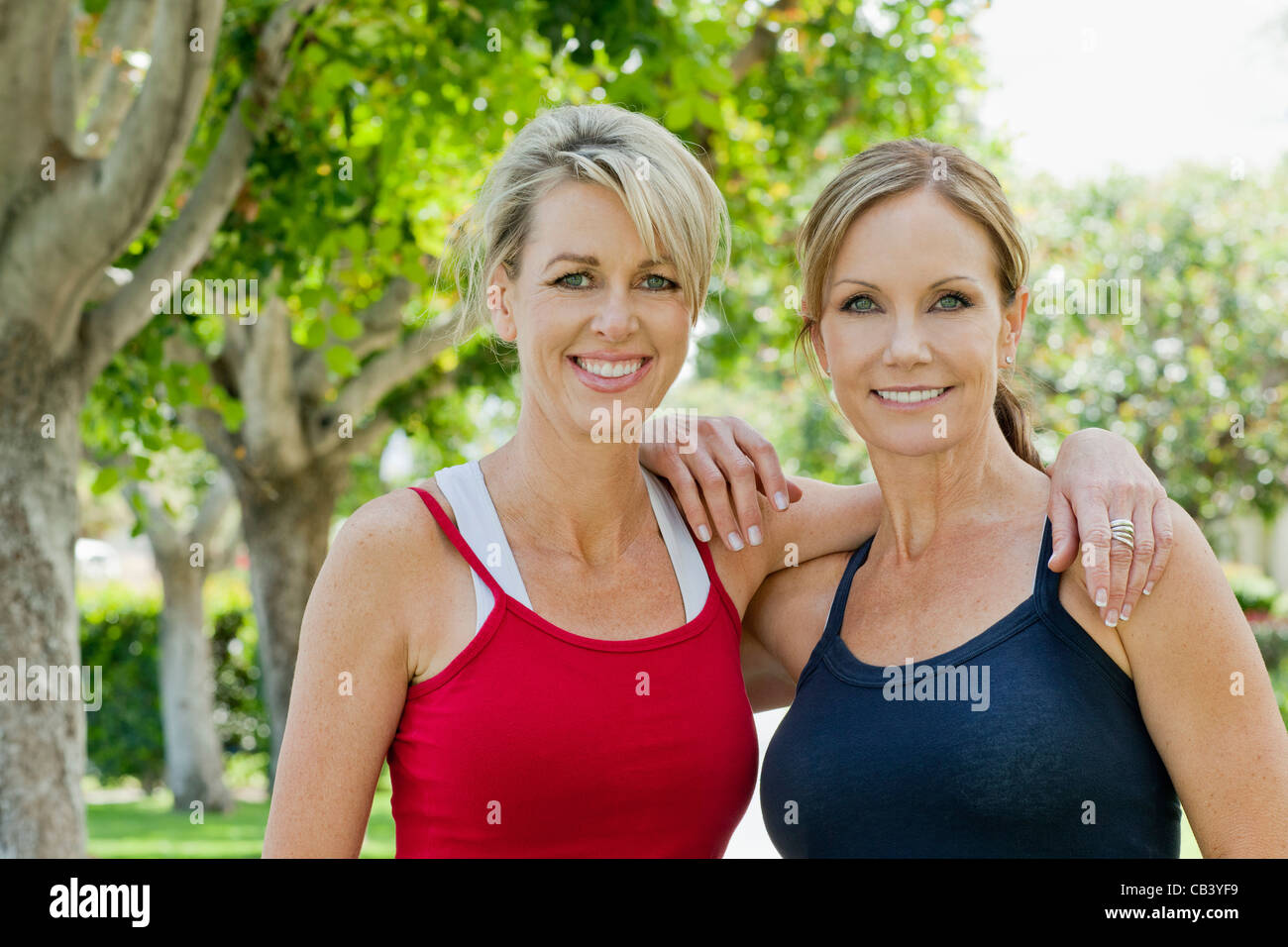 Portrait of two mature women smiling with arm around each other Stock ...