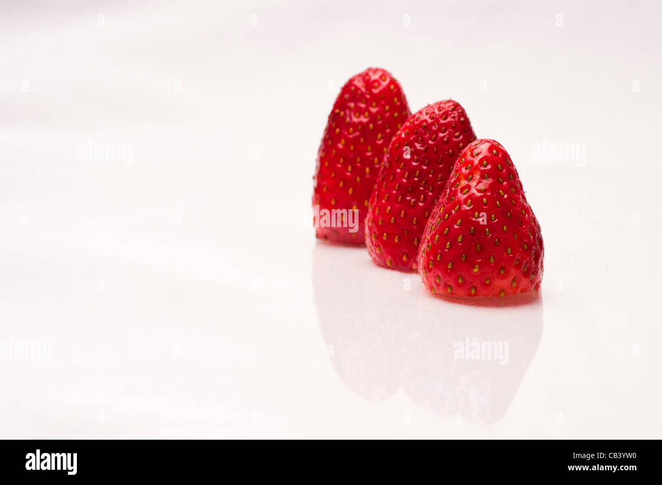 Close up of strawberries on white background Stock Photo - Alamy