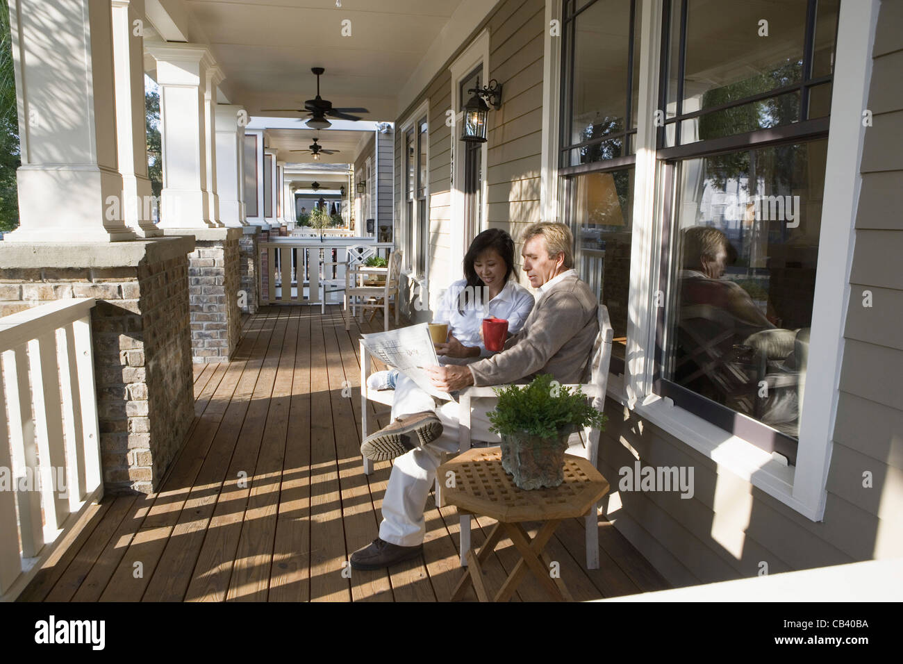 Interracial couple sitting on the front porch Stock Photo Alamy