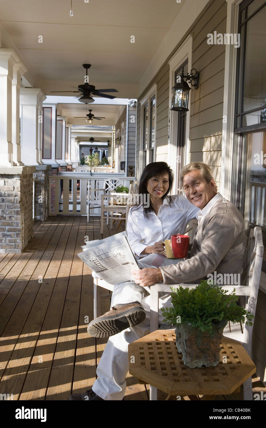 Interracial couple sitting on the front porch Stock Photo Alamy