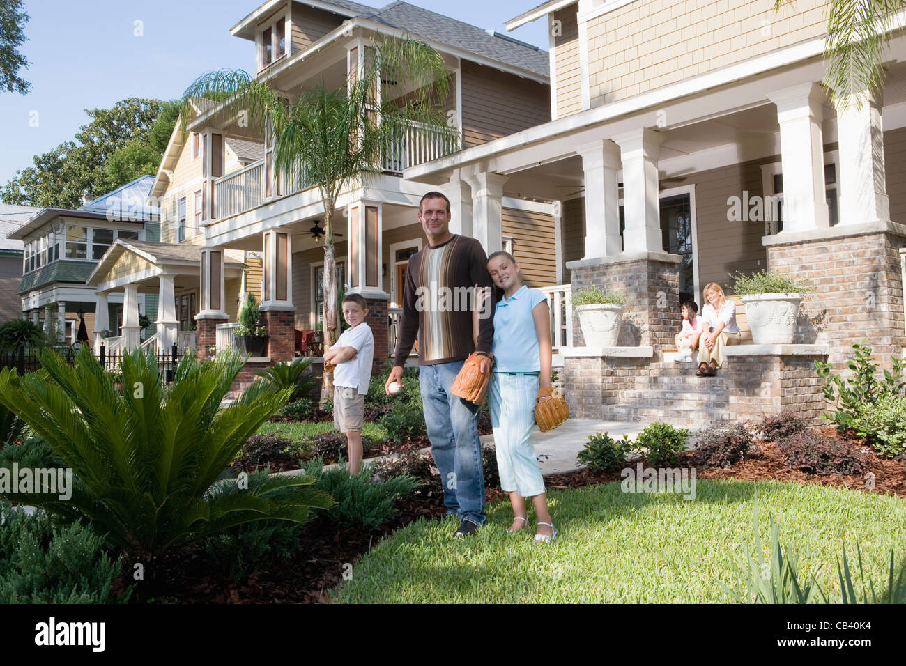 Portrait of a family in front of their house Stock Photo - Alamy