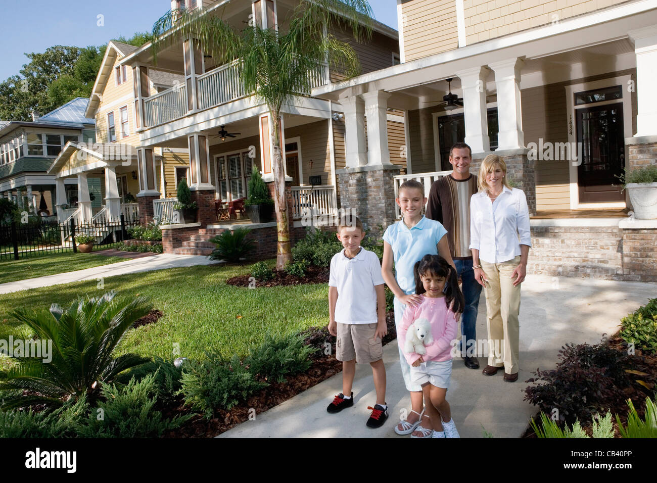 Portrait of a family in front of their house Stock Photo - Alamy