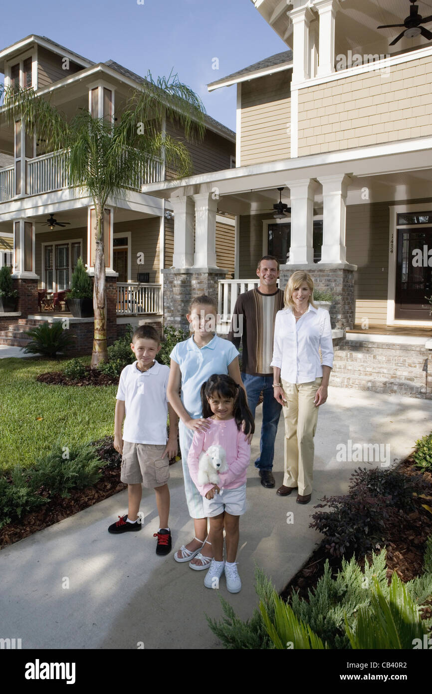 Portrait of a family in front of their house Stock Photo - Alamy