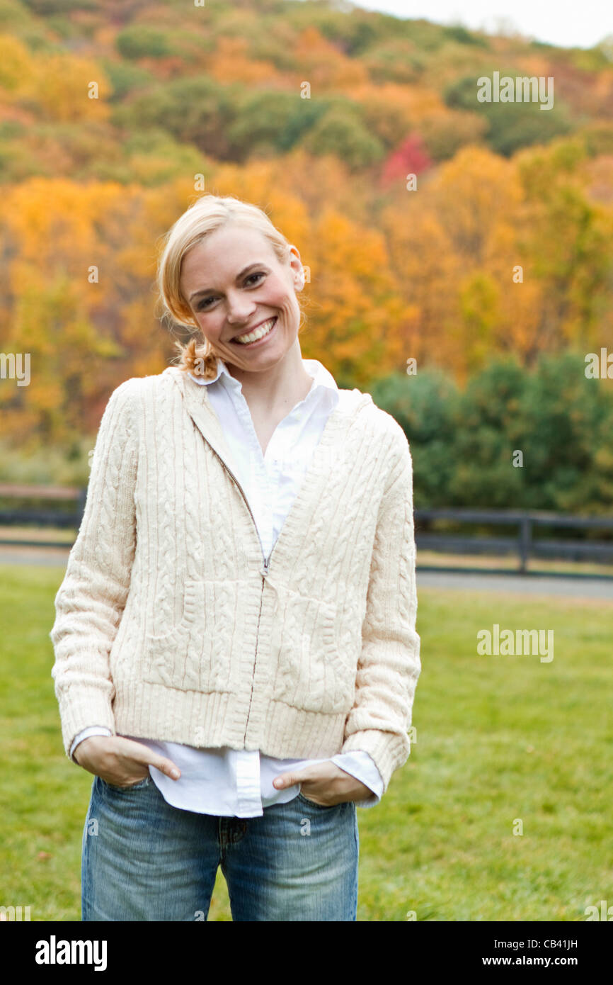 Portrait of woman standing on field Stock Photo - Alamy
