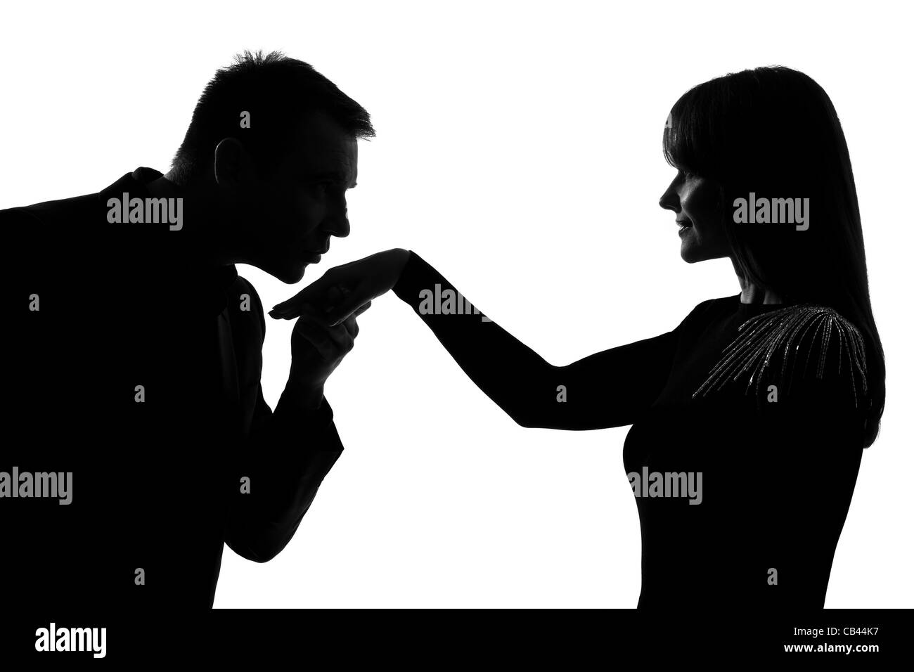 one caucasian man kissing hand woman  in studio silhouette isolated on white background Stock Photo