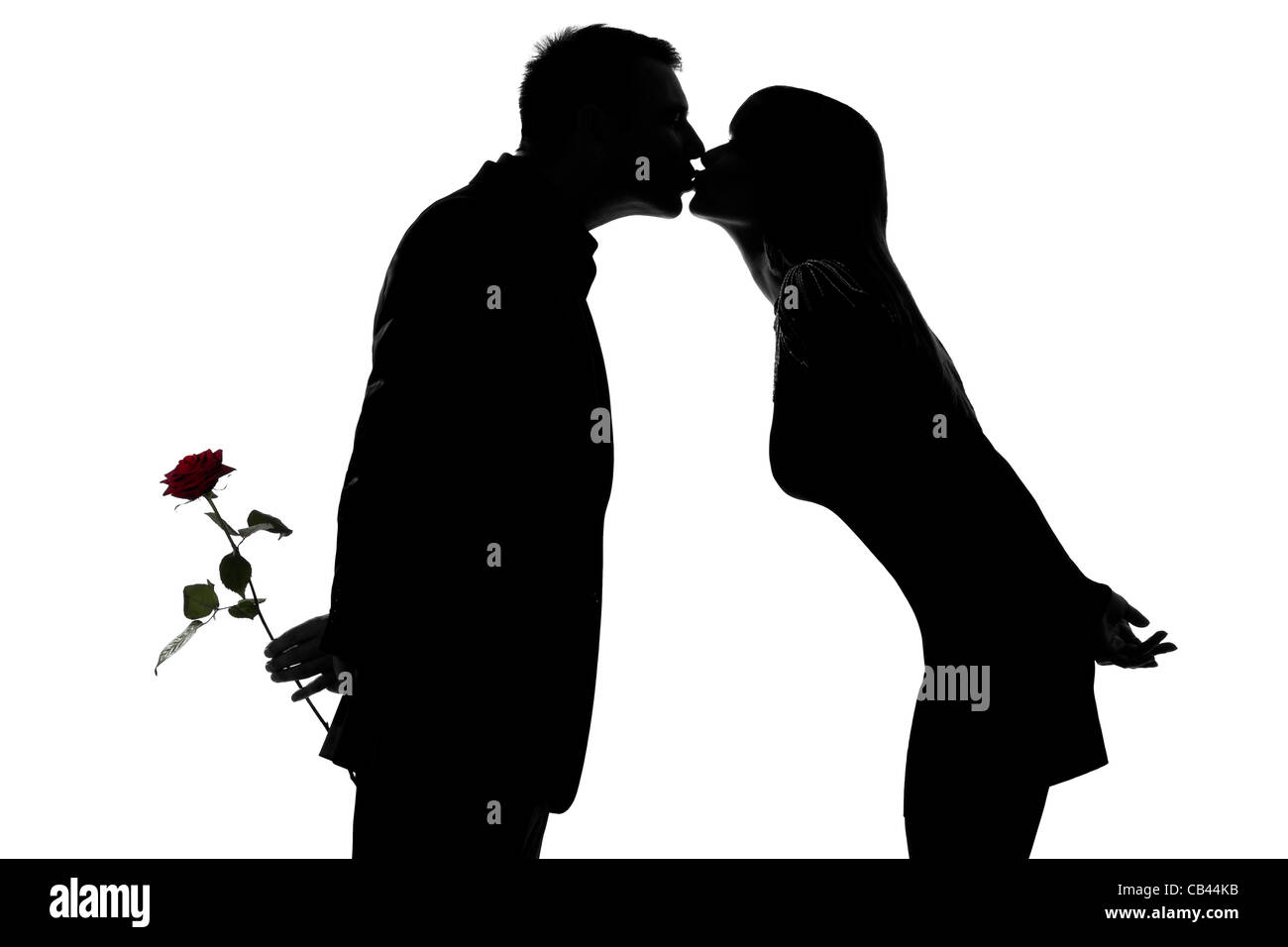one caucasian couple man and woman kissing in studio silhouette isolated on white background Stock Photo