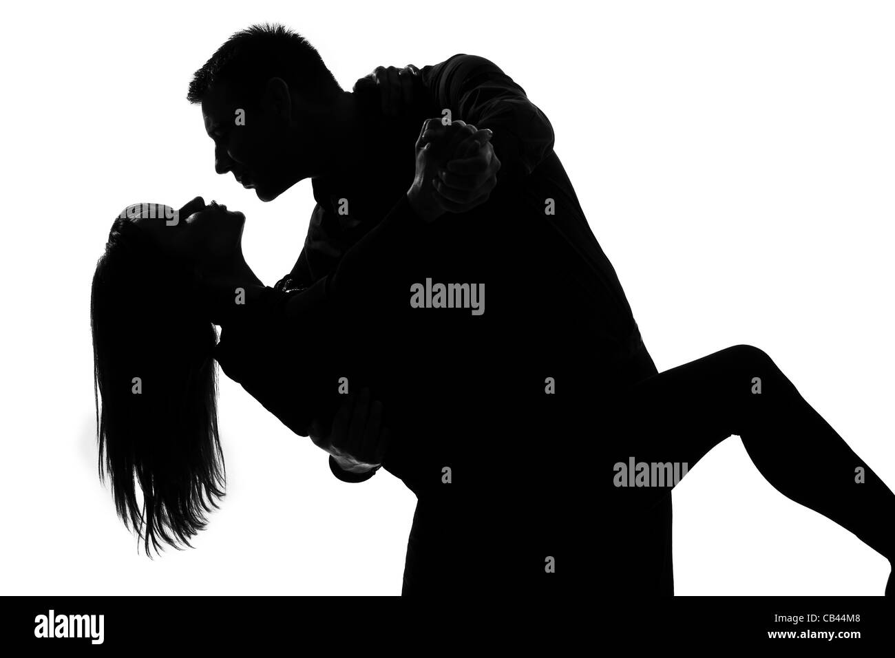 one caucasian couple lovers  man and woman dancing tango in studio silhouette isolated on white background Stock Photo