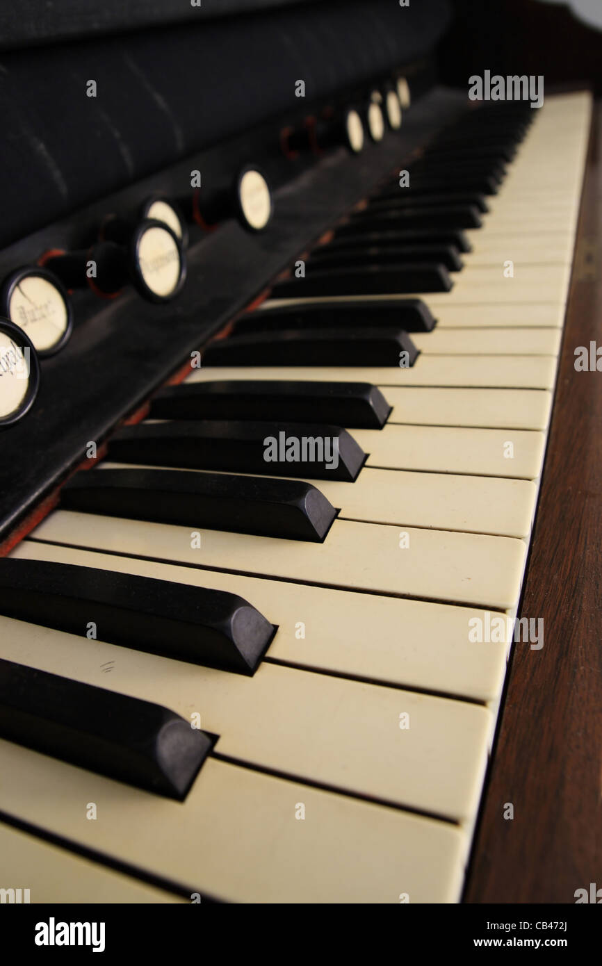 vertical image of an antique pedal organ keyboard with shallow depth of field Stock Photo