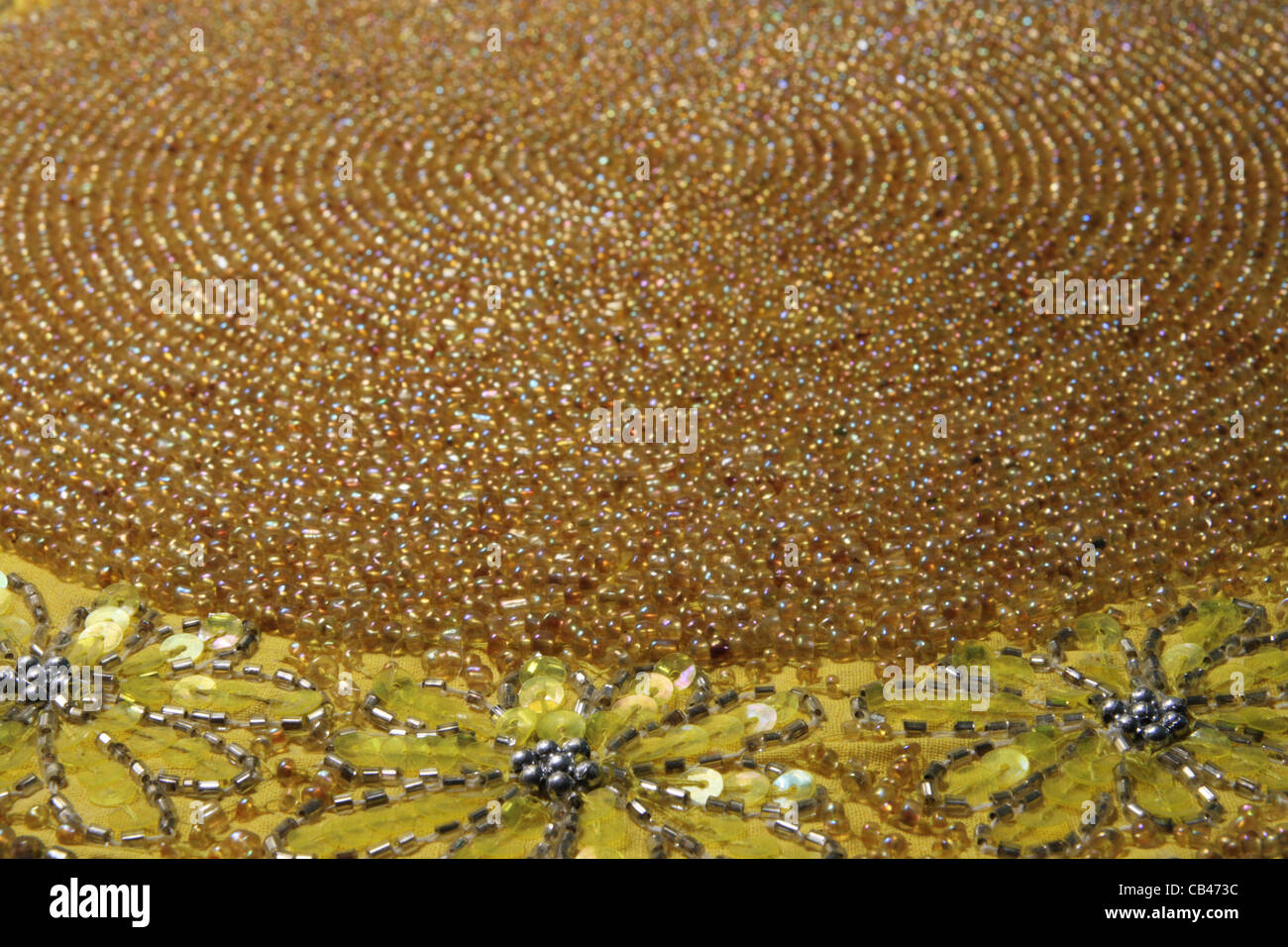 antique yellow beaded mat from an angle with a shallow depth of field Stock Photo