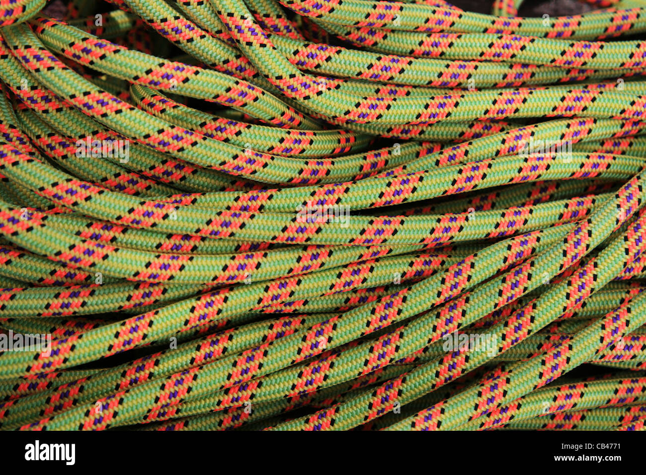 coiled up colored rock climbing rope background Stock Photo