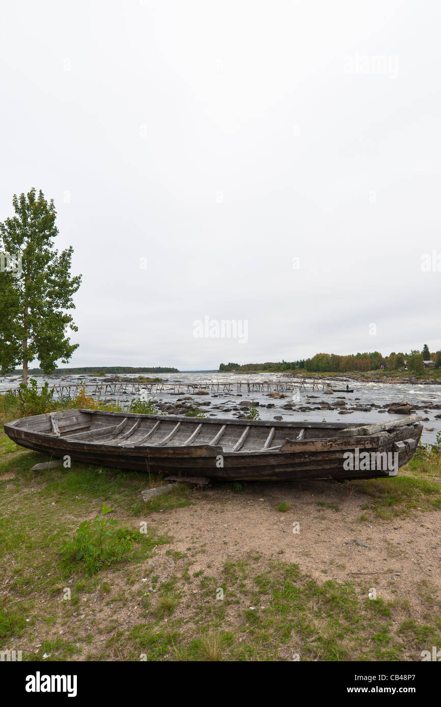 Boat for whitefish capture with fish landing net in Torne river, Kukkola stream, on the border between Sweden and Finland. Stock Photo
